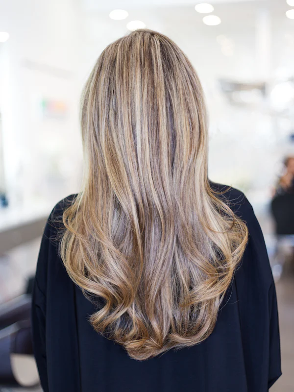 Long blonde hair in soft waves, seen from behind